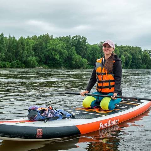 Customer sit on Funwater paddle board blow up and smile