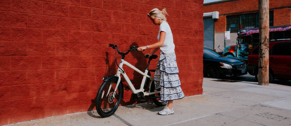Woman with Benno Boost electric bike on sidewalk