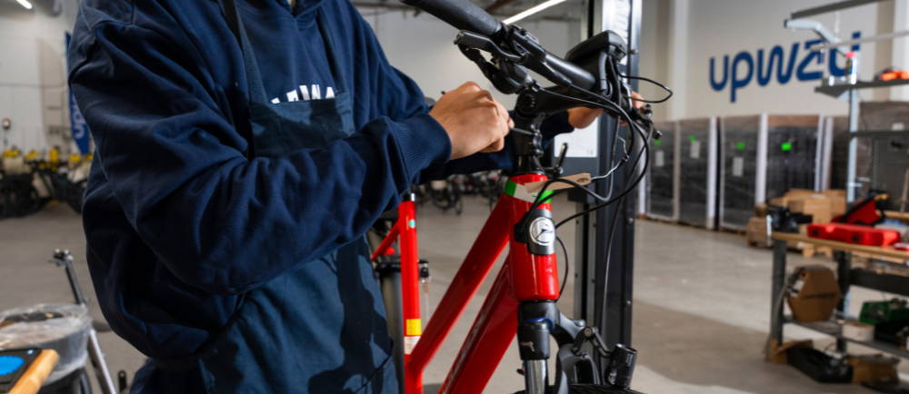 Upway mechanic repairing bike at Los Angeles UpCenter