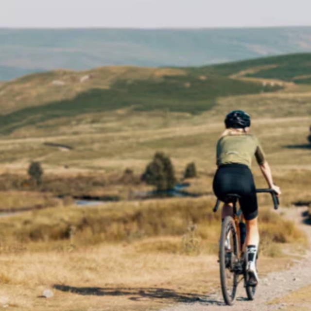 a person riding a gravel bike in the wilderness