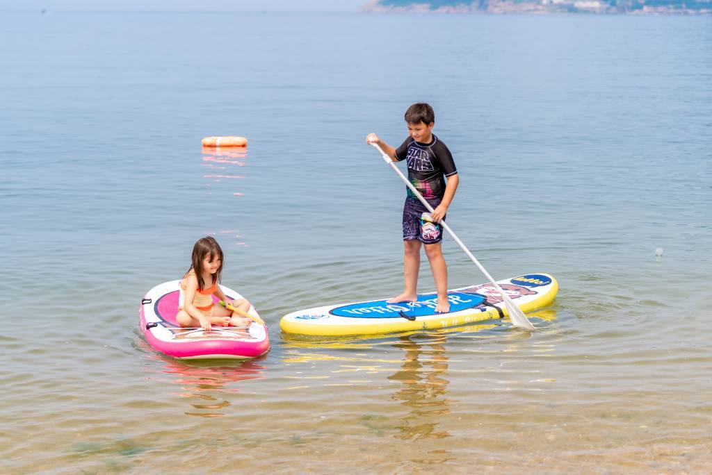 Kids paddle board in Canada