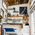 A kitchen and living area with high wooden ceilings