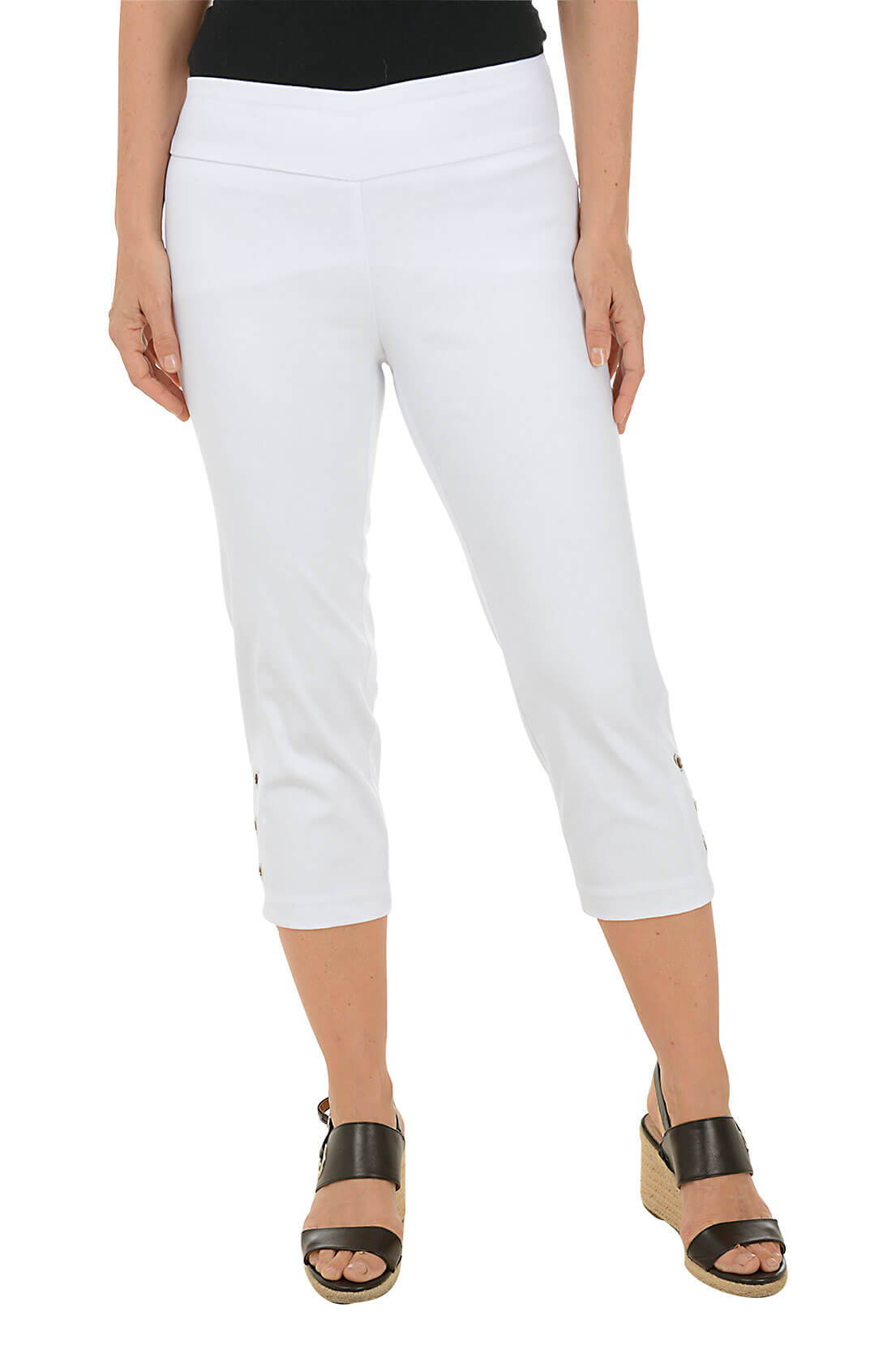 A woman wears a white crop pant with grommet details on the hem against a white background