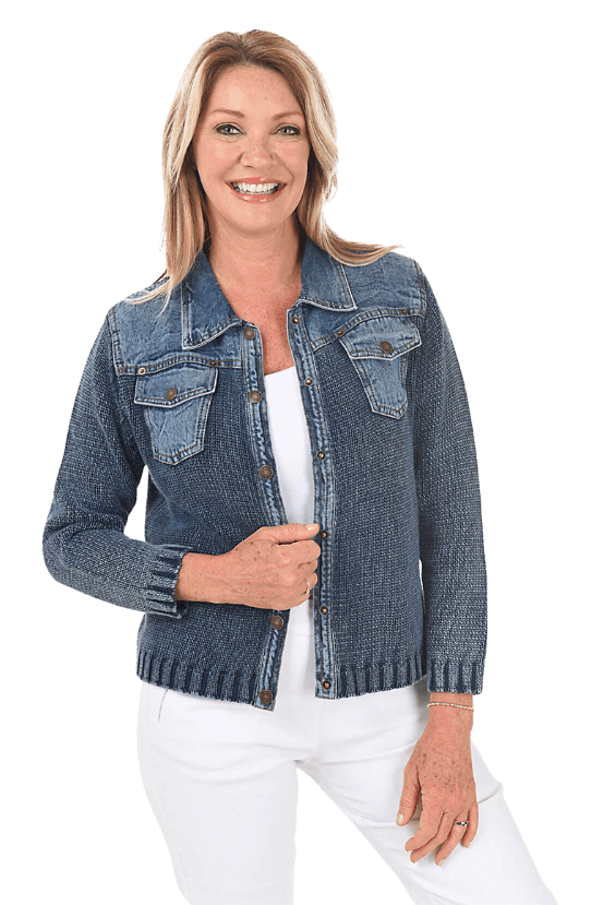 A woman wearing a blue denim sweater jacket over a white tank and white pants