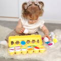 Little girl sitting on a fluffy carpet and playing with her Montessori Generation Eggs. 
