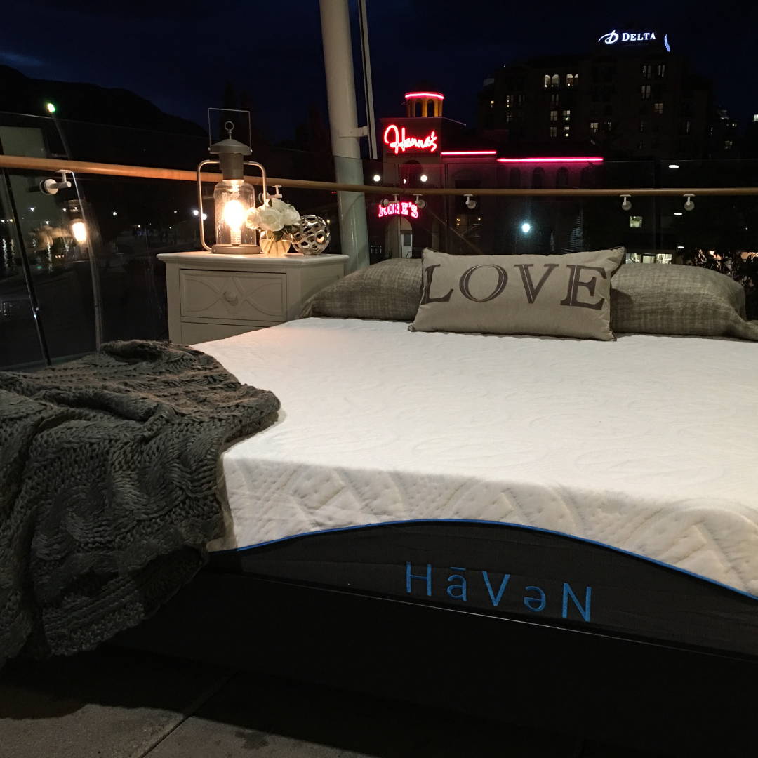 room with Haven mattress at nigh time with city skyline in background.