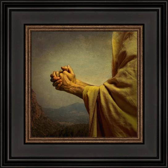 Framed picture of Jesus' hands clasped in prayer.