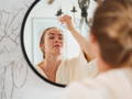 woman applying retinol to her skin