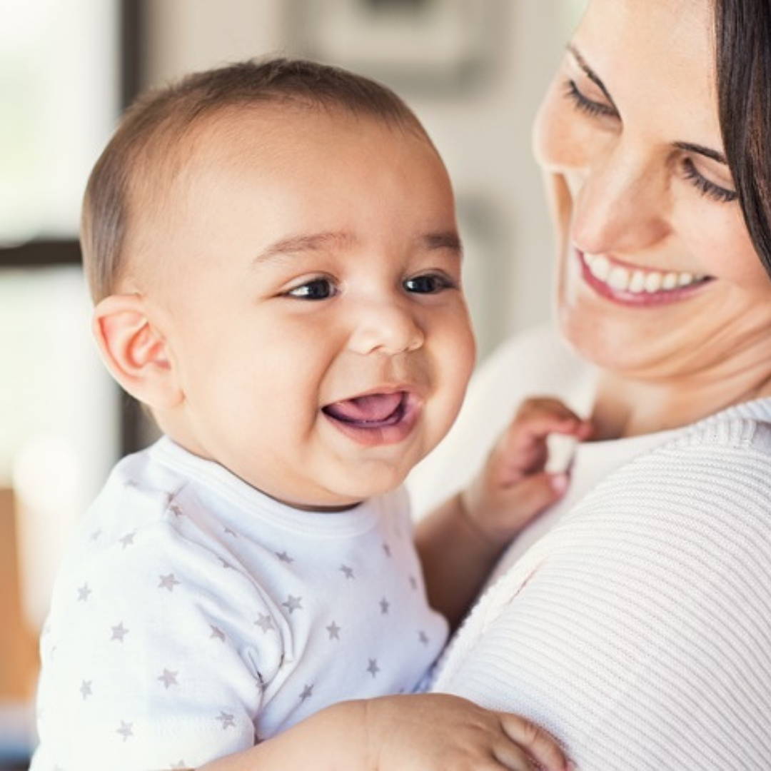 Happy baby in mother's arms