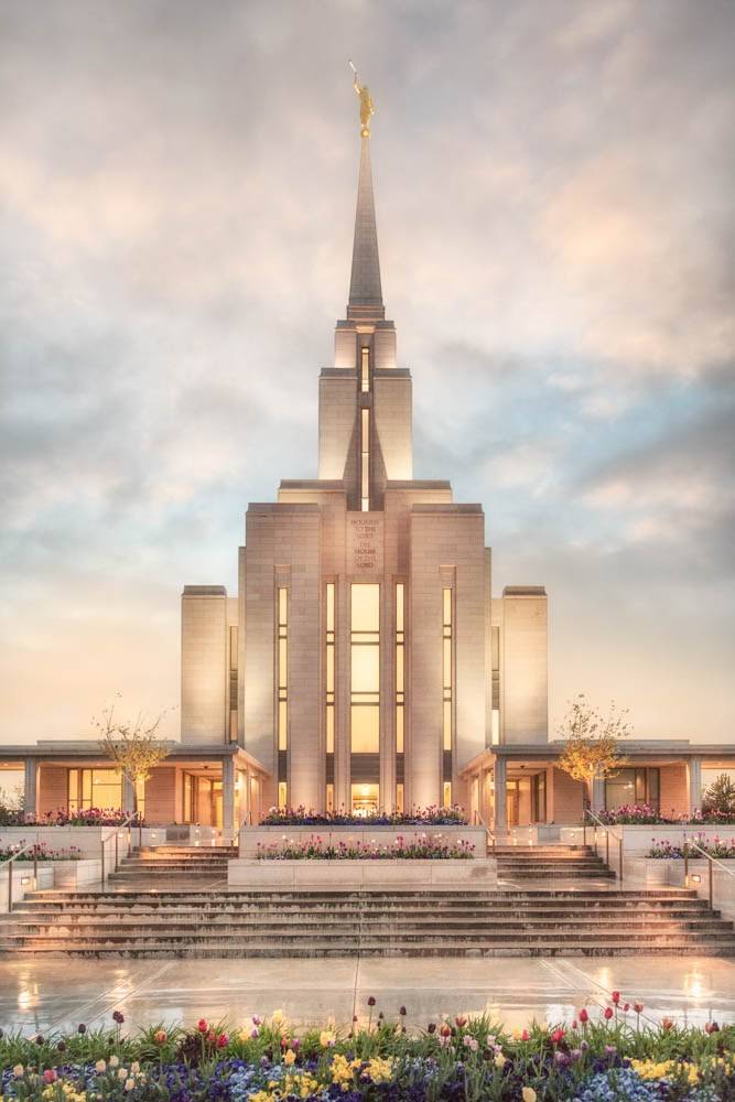 LDS art vertical photo of the Oquirrh Mountain Temple glowing against a cloudy sky.