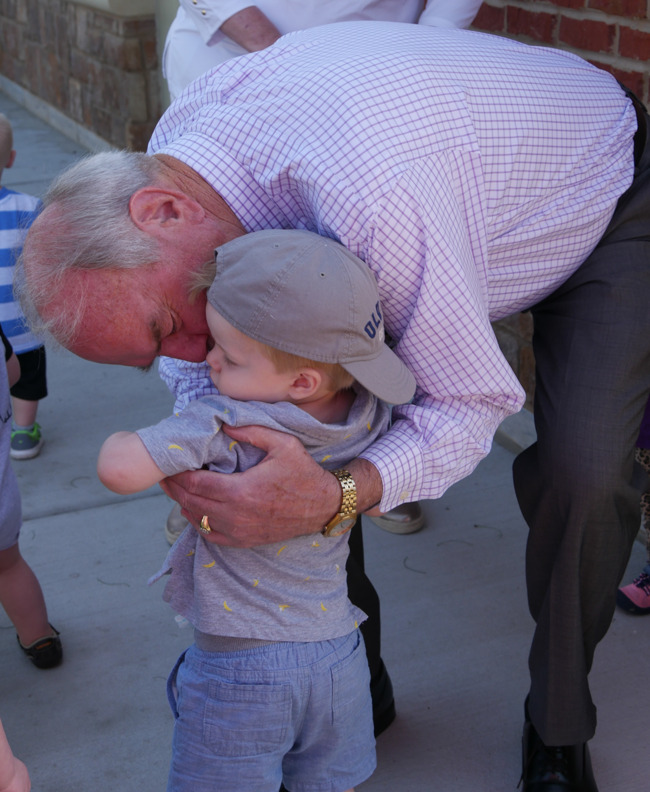 Grandpa and Grandson hug after a fun morning at our grandparent event.