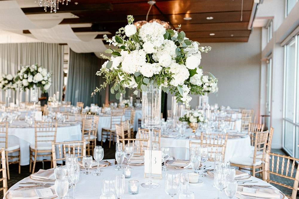 Tall white and green centerpiece on guest table