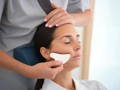 woman having a gua sha face massage