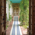striped indoor outdoor rug on steps in entry