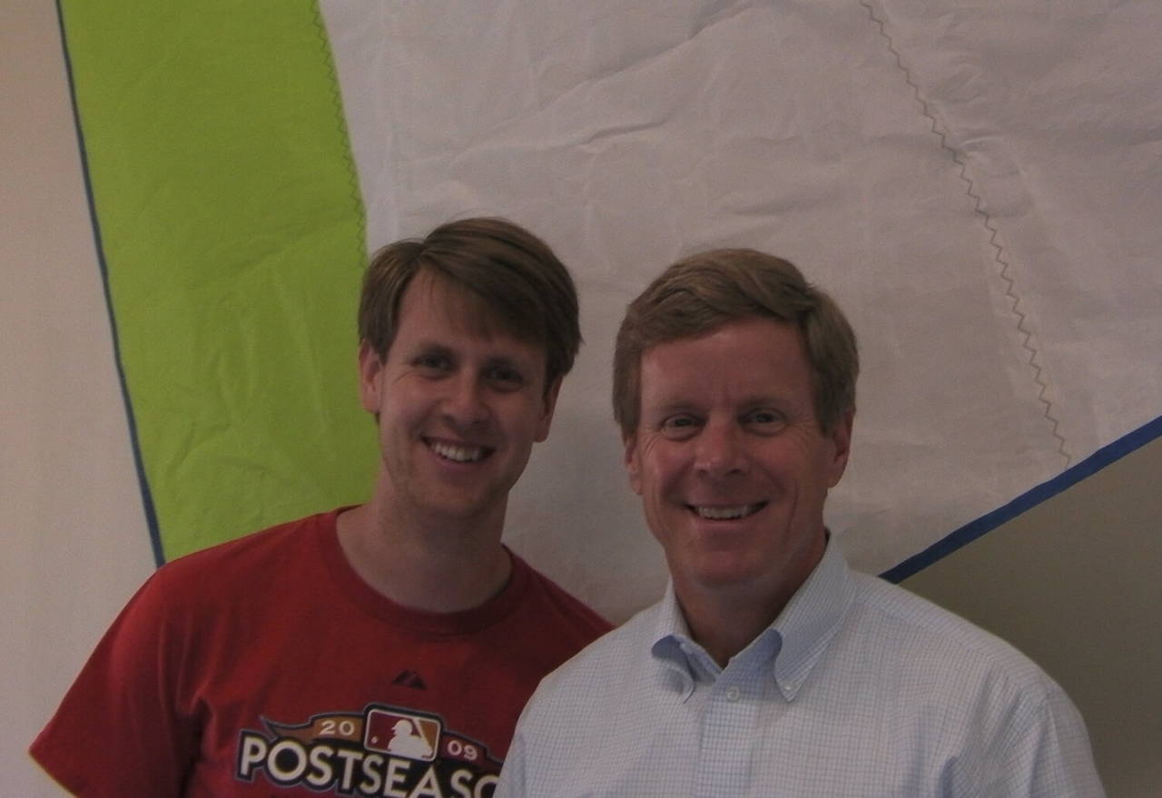 Dean and Robert standing in front of a sail