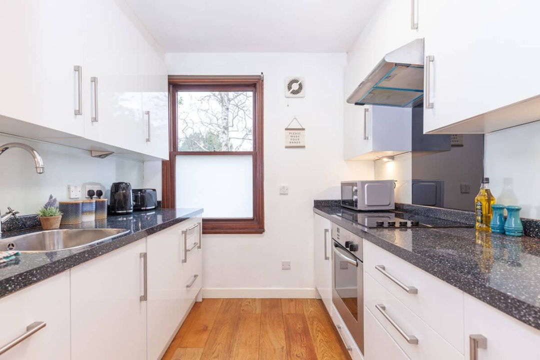 Kitchen showing a long kitchen with work surfaces on both sides