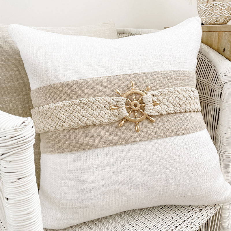 A coastal decorative cushion featuring a sailors wheel as the cushion accent. Perfect for your coastal decorations.