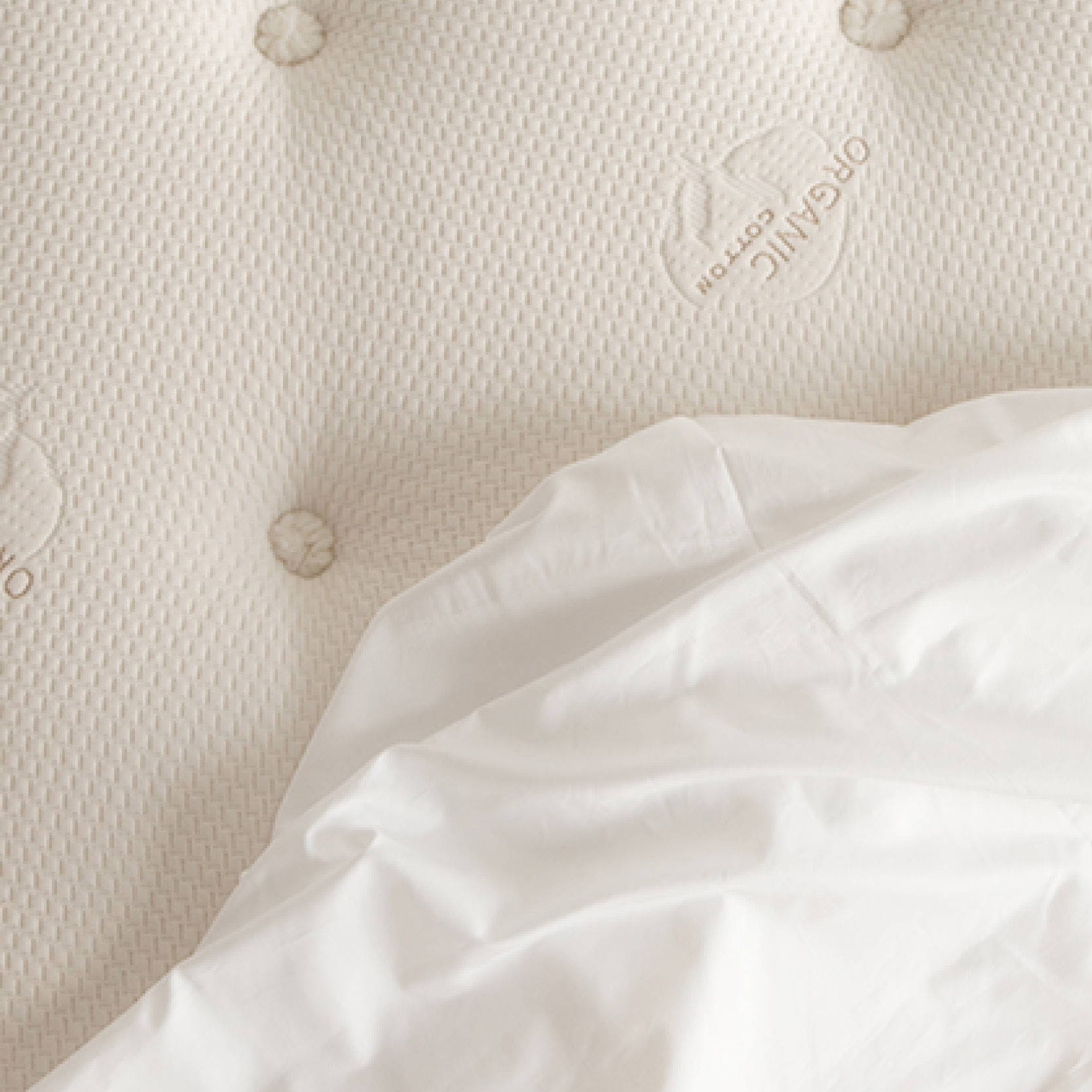 Close up of organic cotton mattress top and sheet. Image