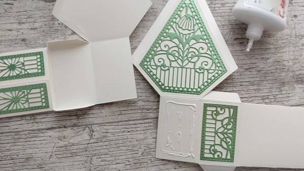 a white and green card with a green design