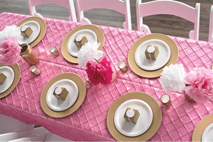 pink bombay pintuck tablecloth with golden plates over it