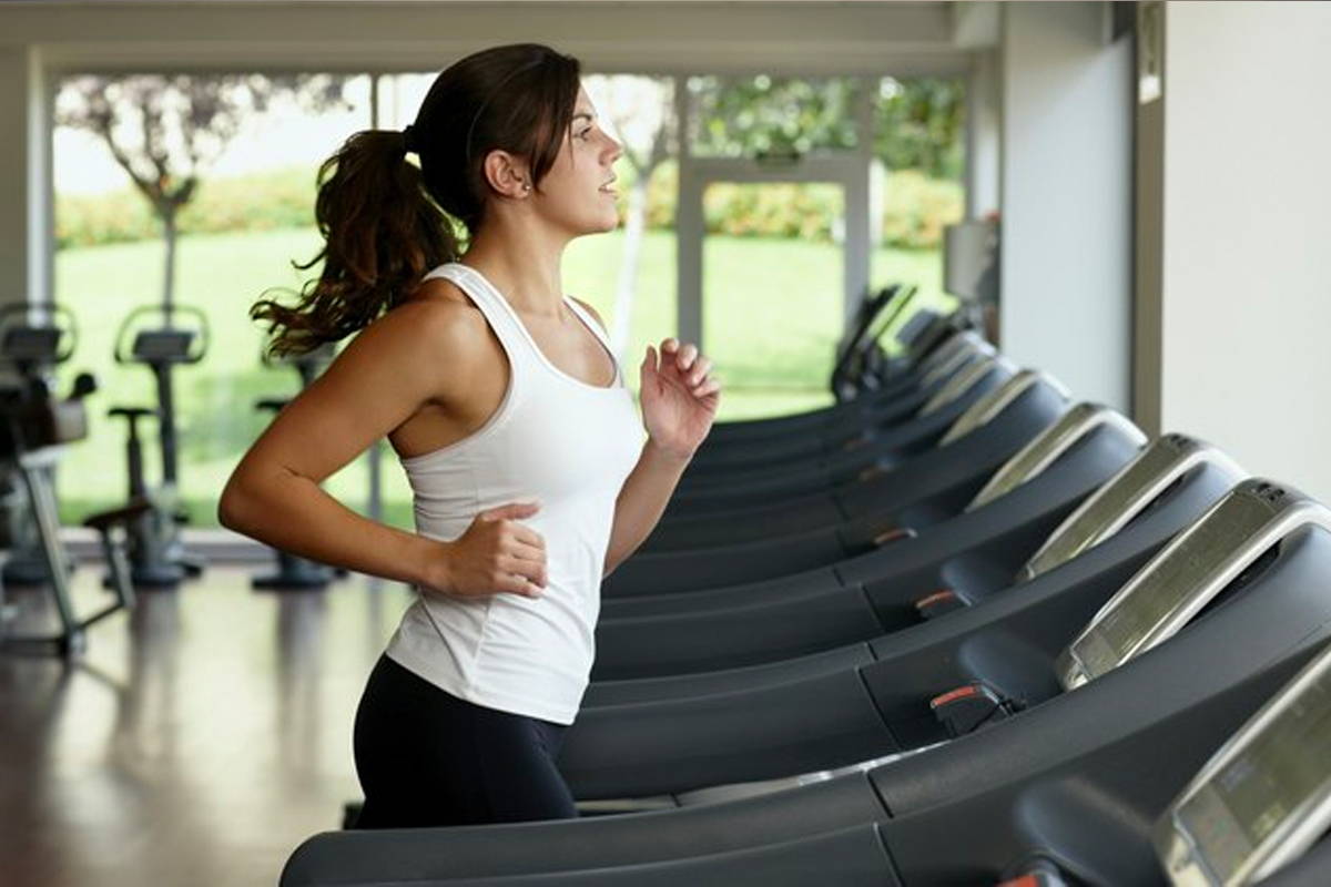 female athlete running on treadmill female athlete running on treadmill