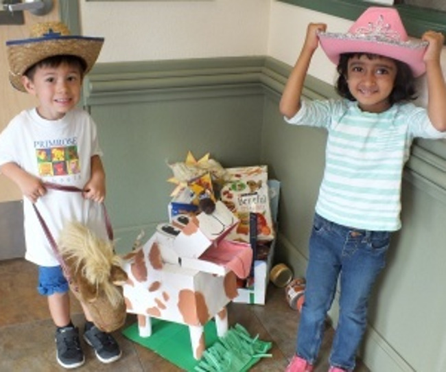 Two Primrose students wearing cowboy hats at the pet food drive 