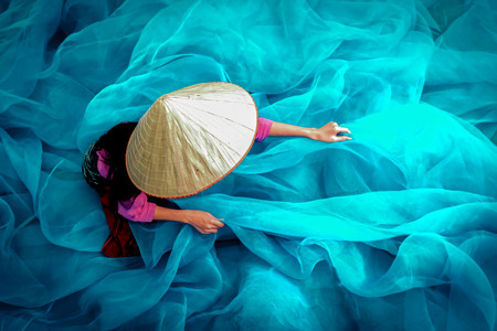 Vietnam Fishermen are repairing fishing nets.jpg