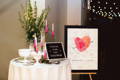 guest book alternative sign displayed on easle next to decorated table