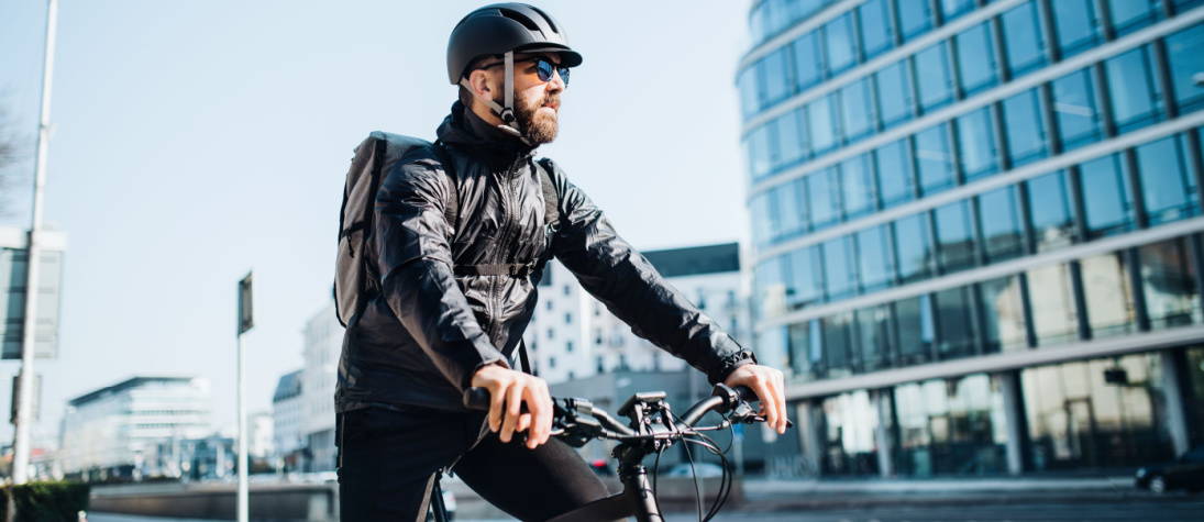 Man Riding Electric City Bike in City