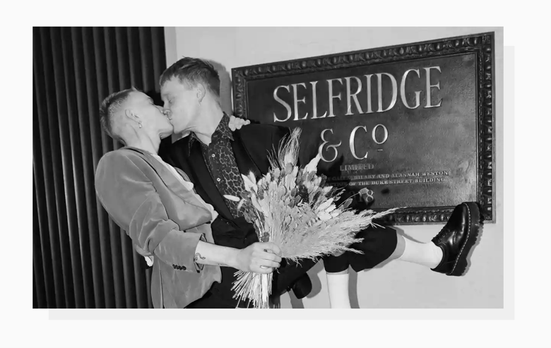 A photo of a happy couple kissing in the Selfridge store