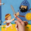Woman's hand placing a lion puzzle piece onto a wooden board to complete the 5 piece twist matching puzzle game. 