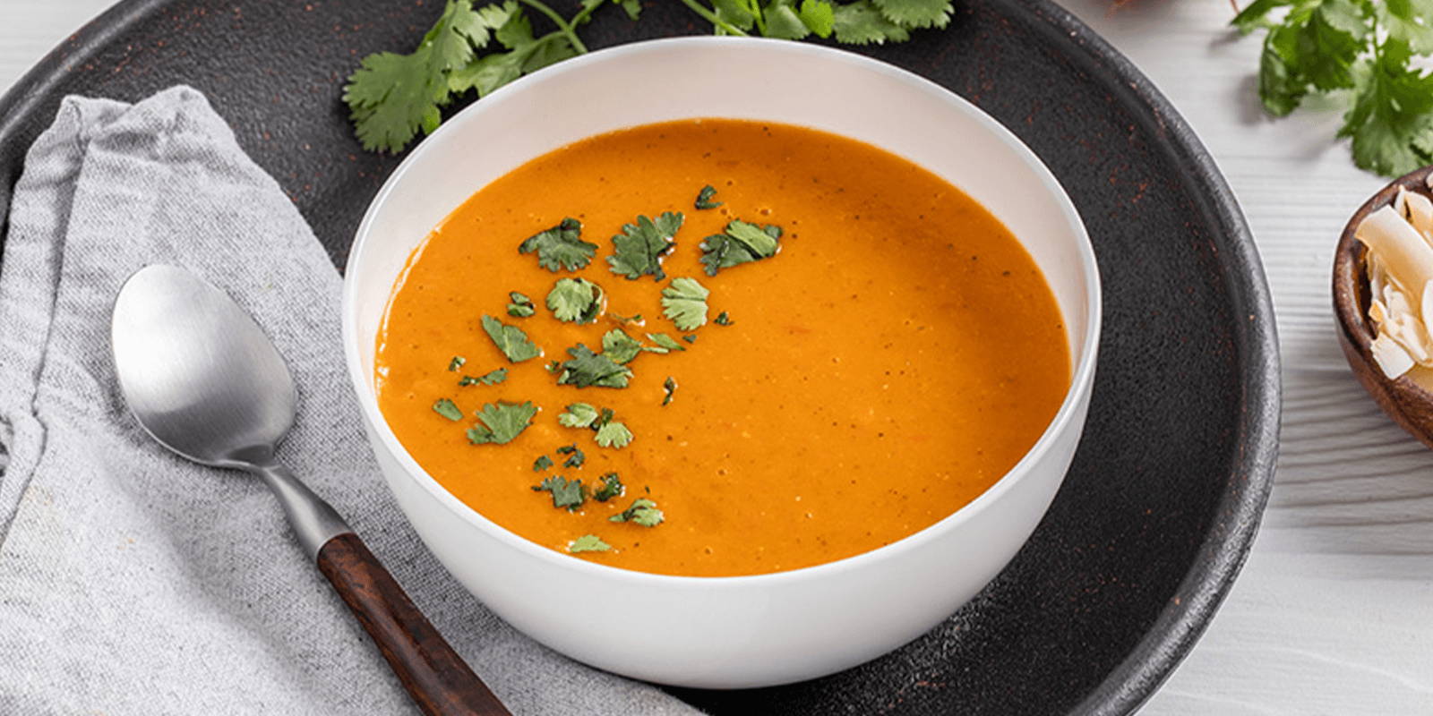 A bowl of tomato soup made with ZENB Sweet Carrot & Tomato Pasta Sauce and coconut.