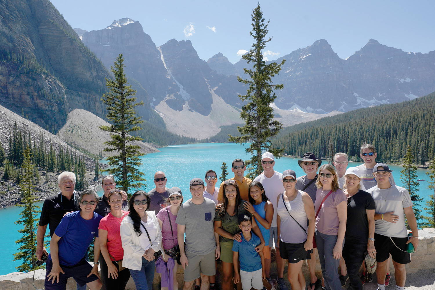 Group of people posing with the Canadian Rockies in the background