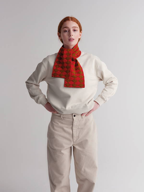 model wears small diamond scarf cumin and poppy