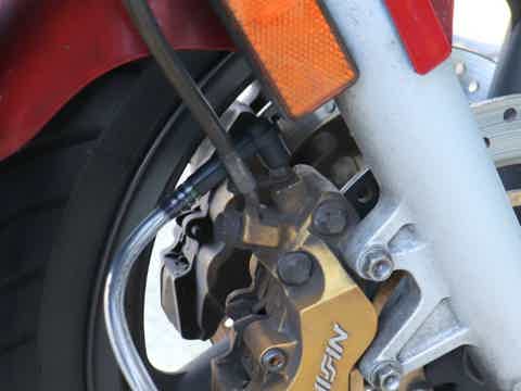 vacuum brake bleeder kit connected to brake bleeder screw. A key step to bleed brake by yourself