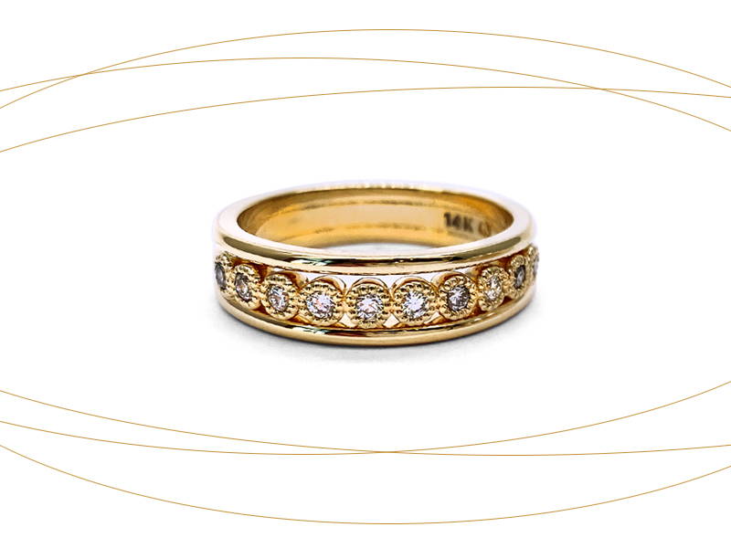 Yellow gold eternity ring with diamonds in small circles welded on the ring body.