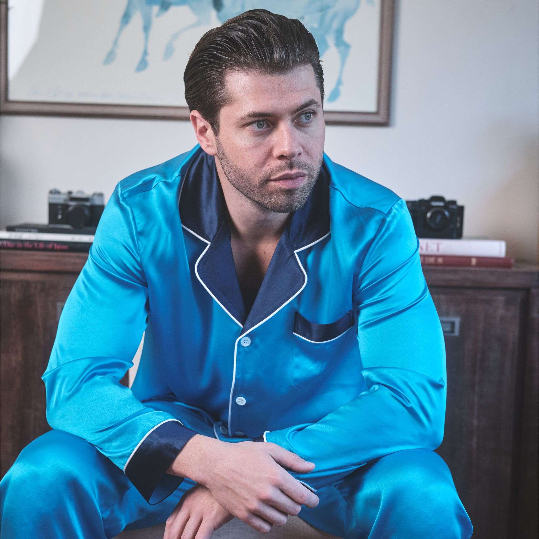 photo of a model wearing blue silk pajamas