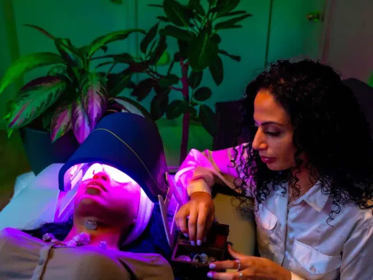 Assorted healthy foods including salmon, nuts, olive oil, and fresh vegetables on a dark surface.