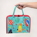Hand holding a Montessori Interactive Busy Bag with Universe elements printed on the covers. 