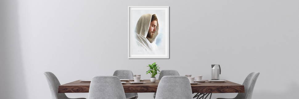 A gentle portrait of Jesus hanging on a wall above a dining table.