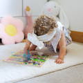 Baby girl playing with a Montessori Alphabet Parking Maze game. 