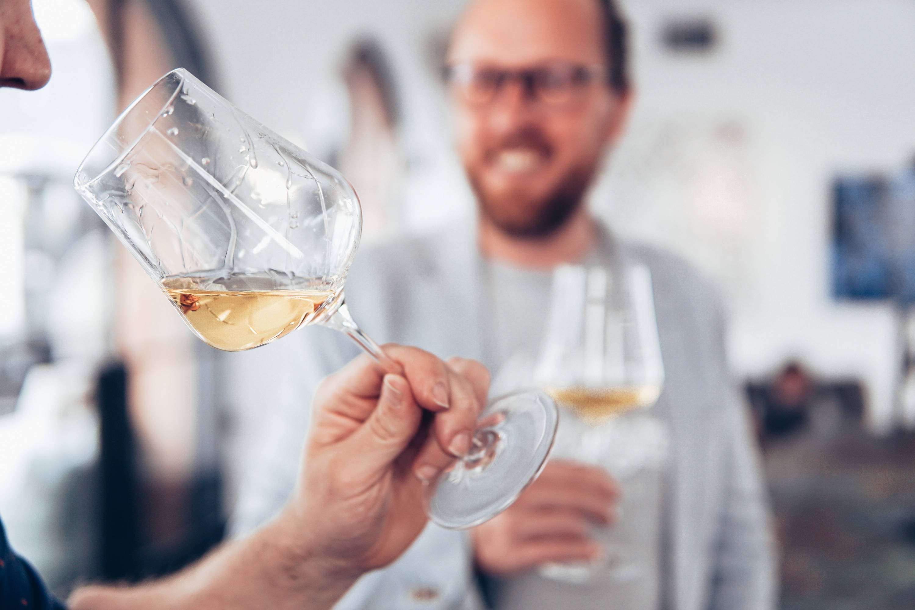 Couple enjoying their natural wine by the glass .