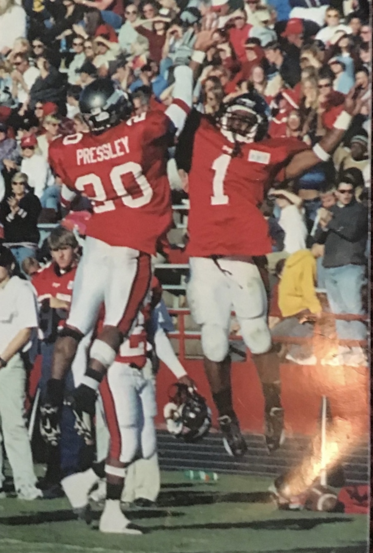 Football celebration in mid-air with Pressley #20