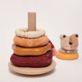Montessori Little Lion Stacker toy featuring a wooden base with a pole, soft fabric and silicone rings, and a topper. 