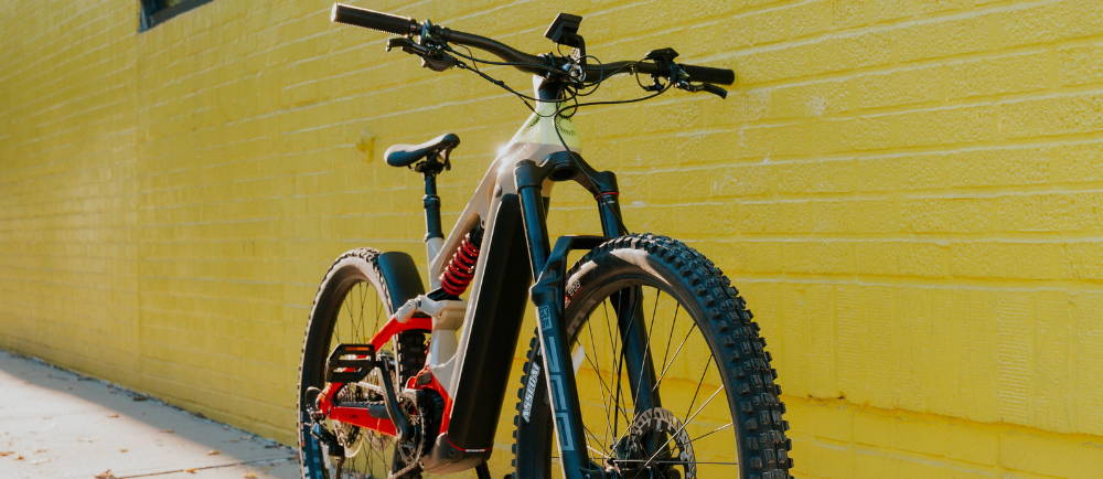 Cannondale Moterra Neo electric mountain bike in front of yellow wall