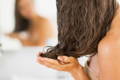 brunette woman damping hair with hands