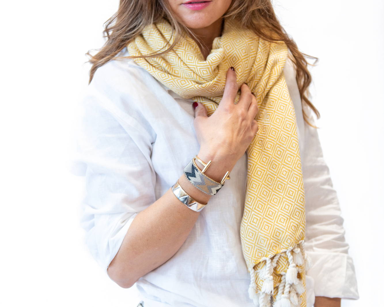 Woman wearing white linen button down with handwoven cotton diamond scarf in yellow & assortment of jewelry - Stick & Ball