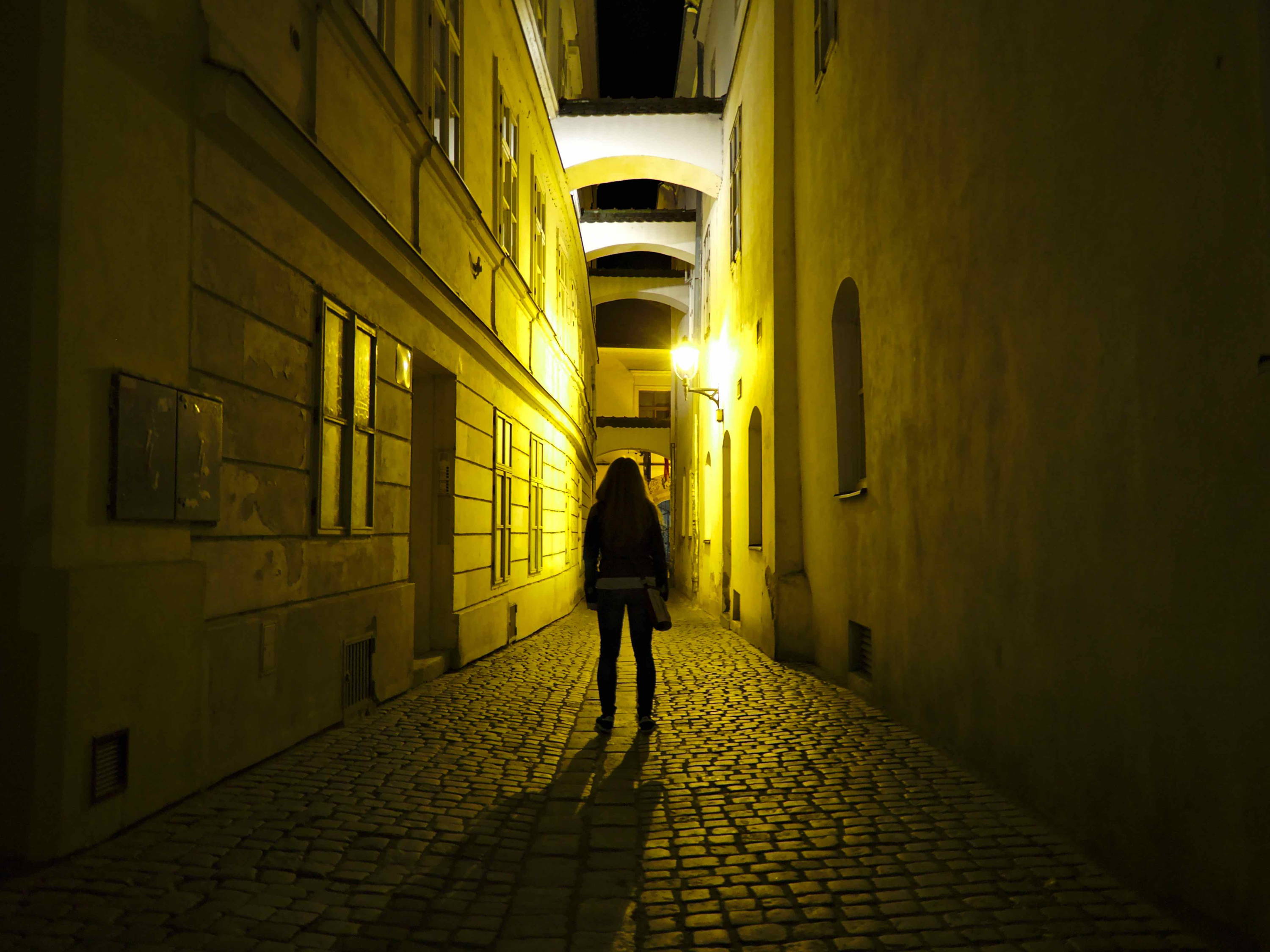 Woman in alleyway at night