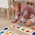 Toddler playing with the Montessori ABC Matching Cards set. 