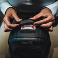 Tozuda indicator on back of helmet, rider placing cover over indicator.